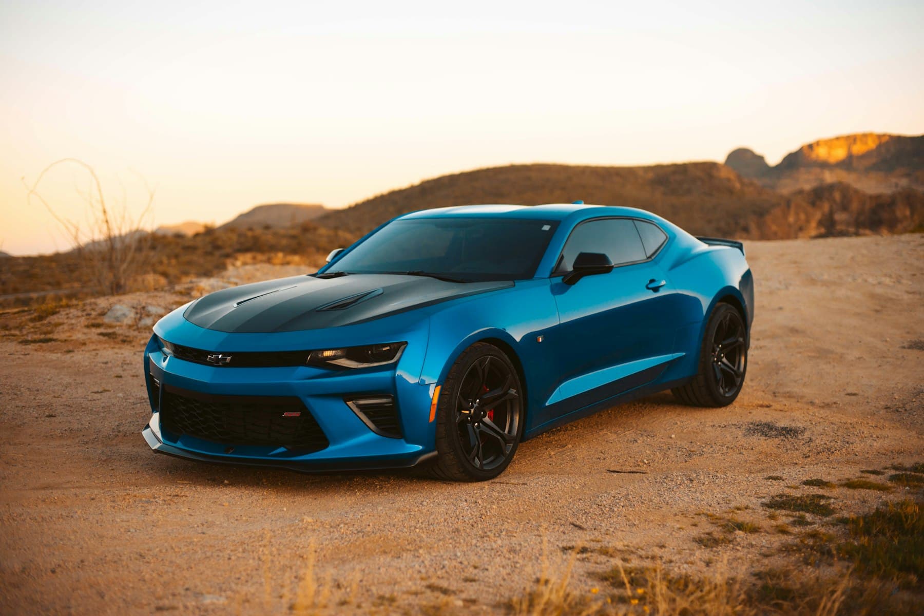 Blue coupe in warm daylight. Demonstration photograph. Not verified work from this shop.