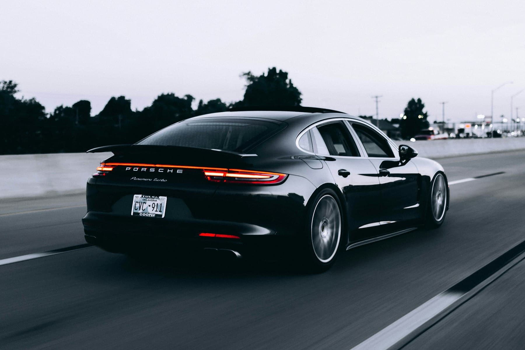 Demonstration photograph of a dark sports car with a glossy finish. Not verified work from this shop.