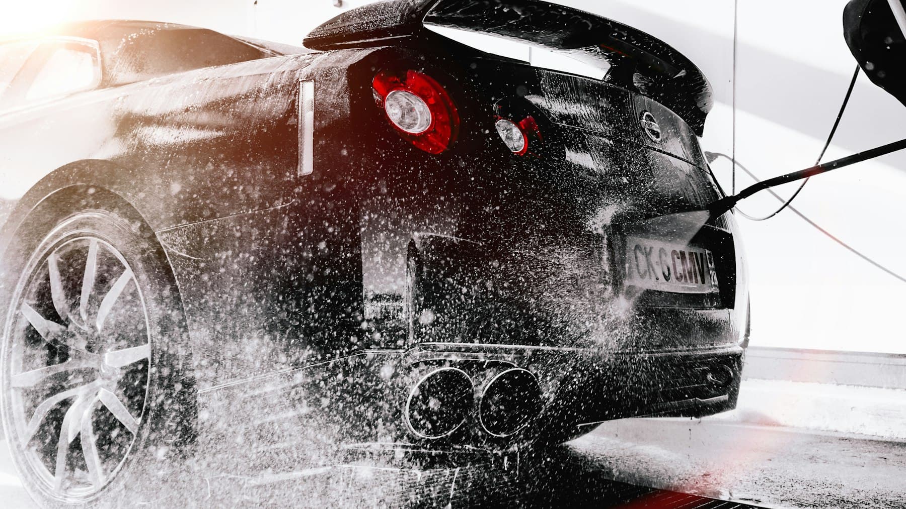 Hand wash foam on a dark vehicle. Demonstration photograph. Not verified work from this shop.